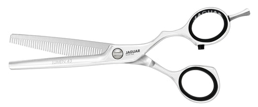 Hairdressing scissors with serrated blades.