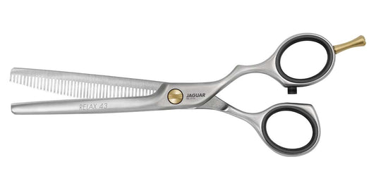 Hairdressing scissors with serrated blades.