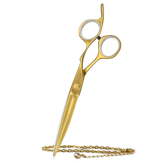 Golden hairdressing scissors with an ergonomic design.