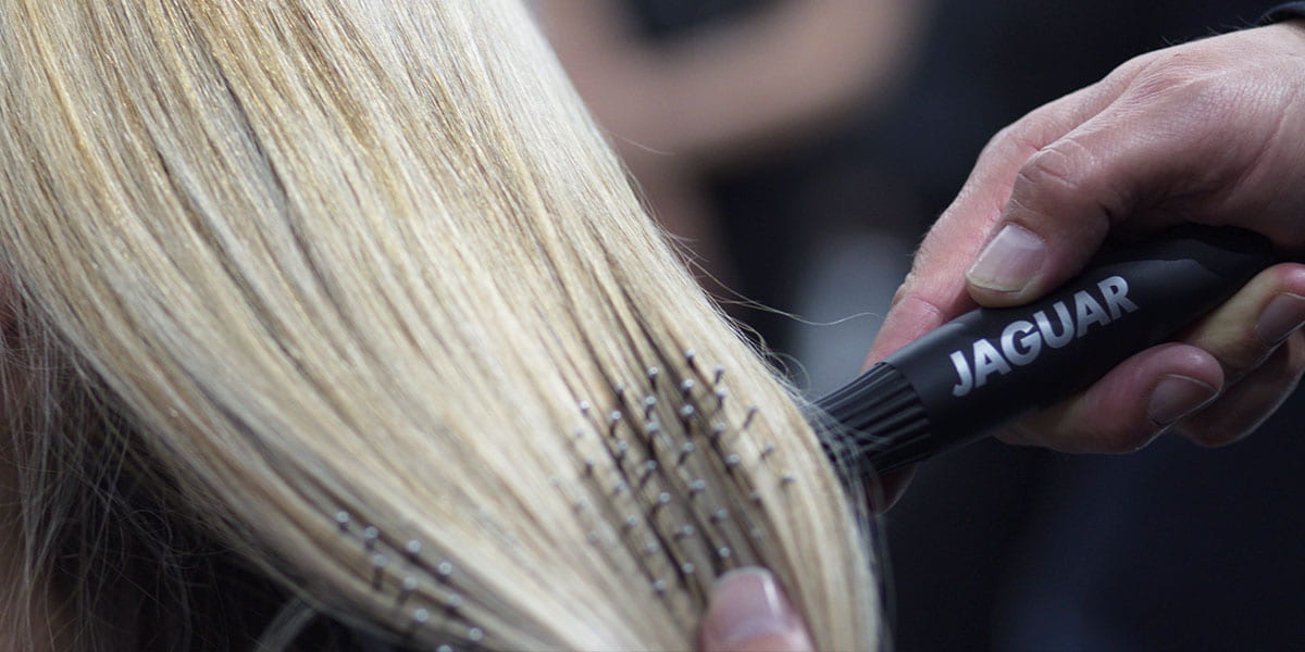 Black paddle brush with bristles.