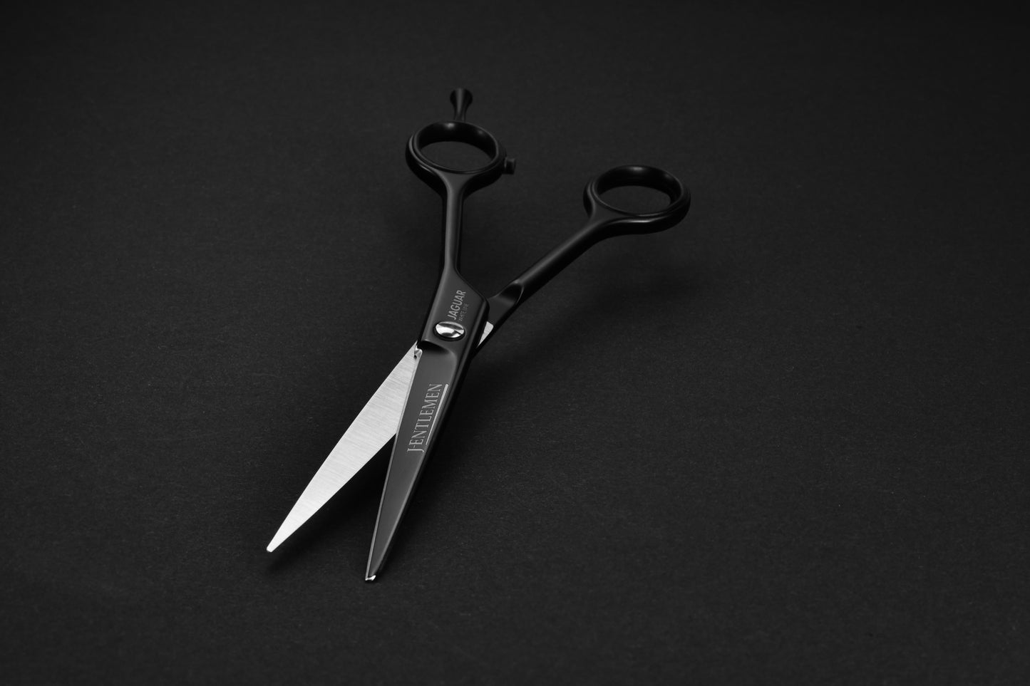 Hairdressing scissors with black handles.