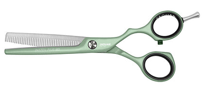 Green hairdressing scissors with teeth.