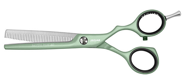 Green hairdressing scissors with teeth.