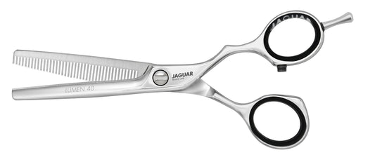 Hairdressing scissors with serrated blades.