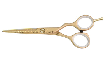 Golden hairdressing scissors with engraving.