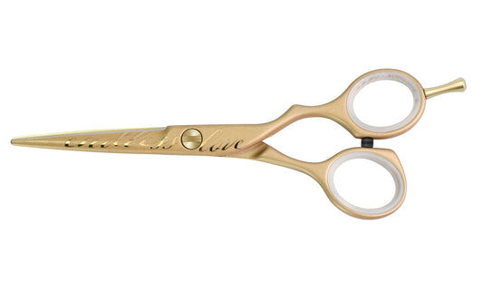Golden hairdressing scissors with engraving.
