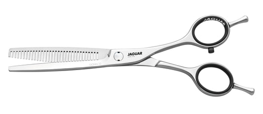 Hairdressing scissors with serrated blades.