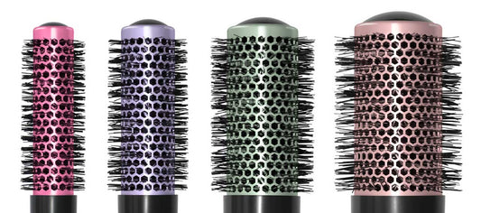 Four colorful round brushes for hairdressers.