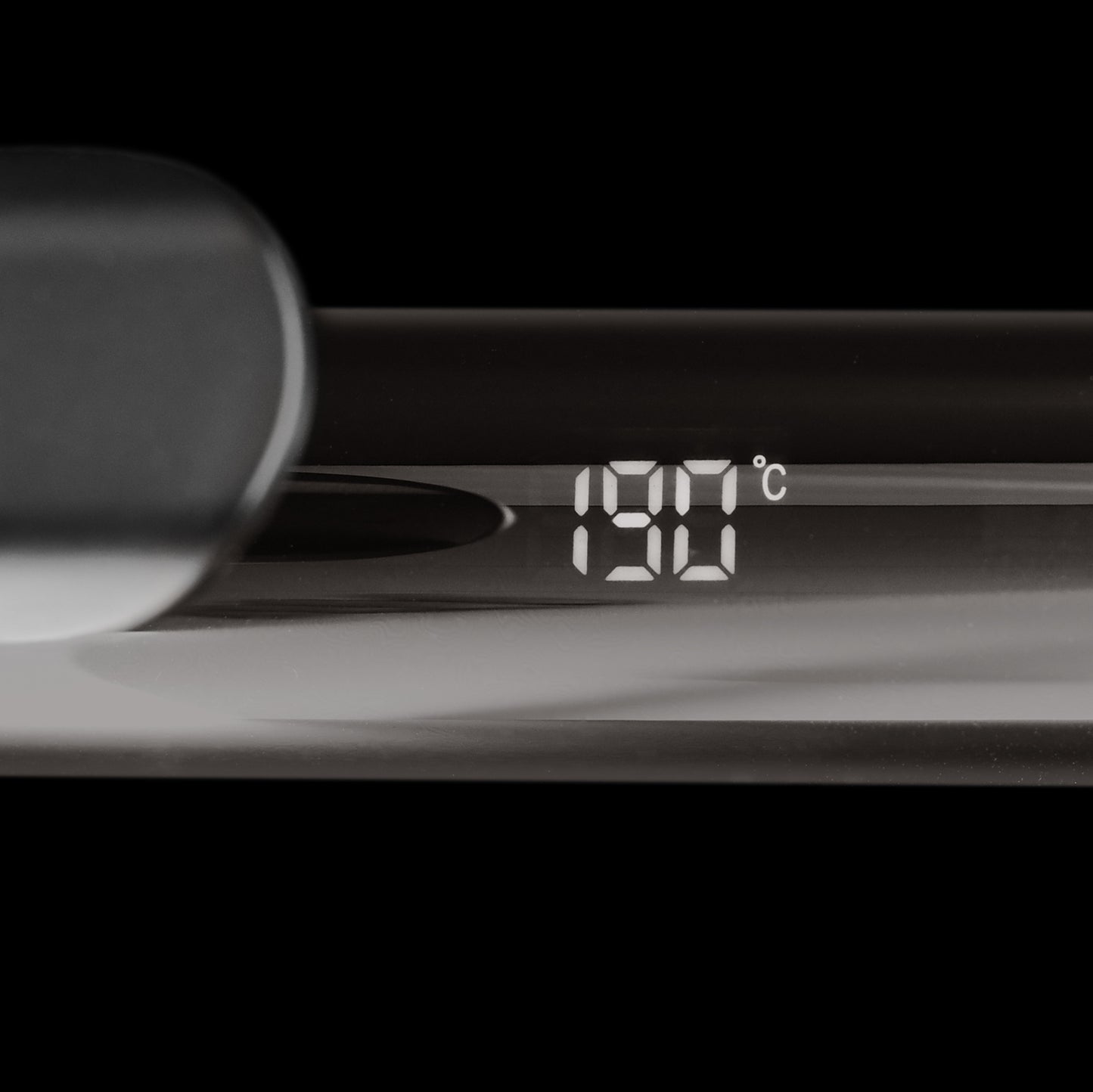 Curling iron with black handle.