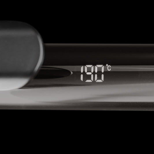 Curling iron with black handle.