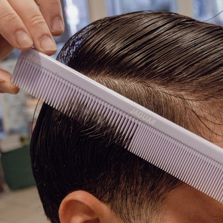 Purple combs in a black bag.