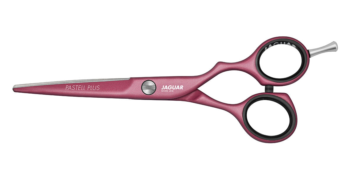 Pink hairdressing scissors with offset handle.