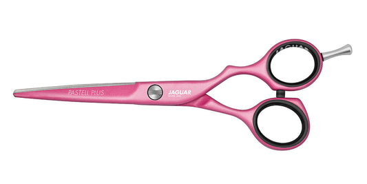 Pink hairdressing scissors with offset handle.