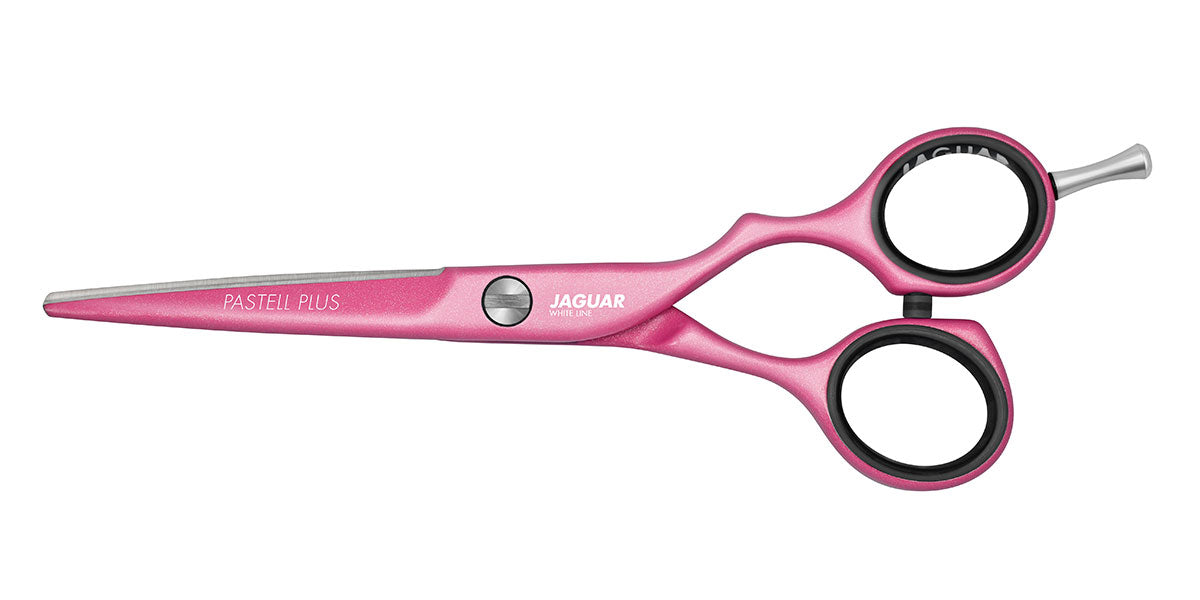 Pink hairdressing scissors with offset handle.