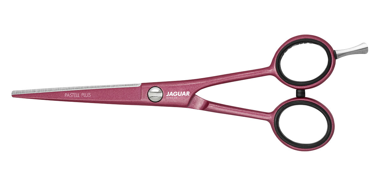 Pink hairdressing scissors with offset handle.