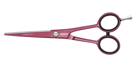 Pink hairdressing scissors with offset handle.