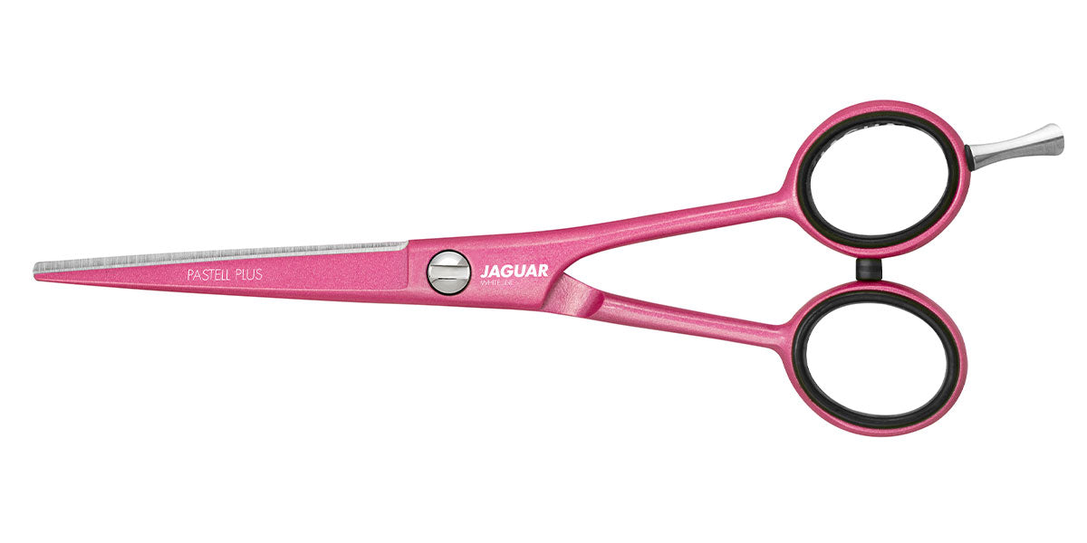 Pink hairdressing scissors with offset handle.