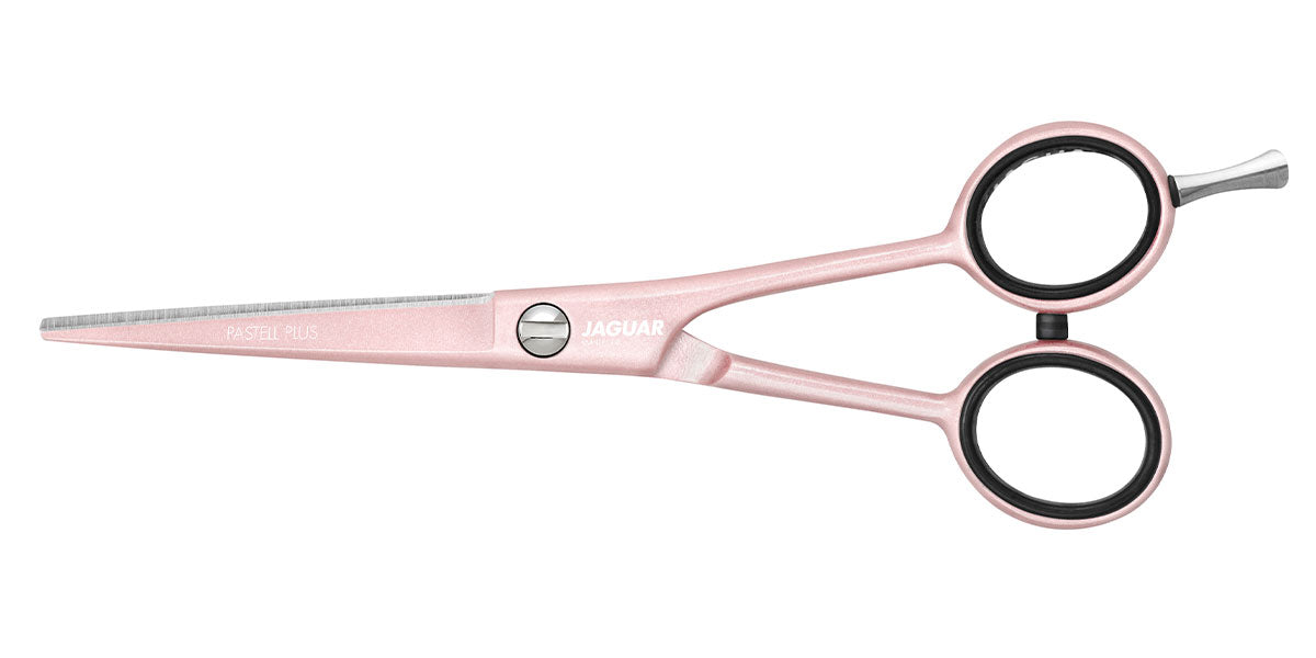 Pink hairdressing scissors with offset.