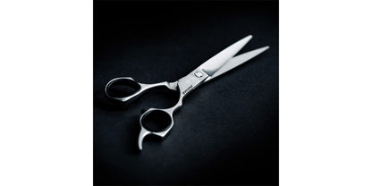 Hairdressing scissors on a black background.