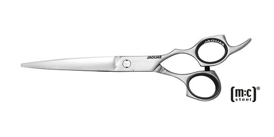 Hairdressing scissors on a black background.