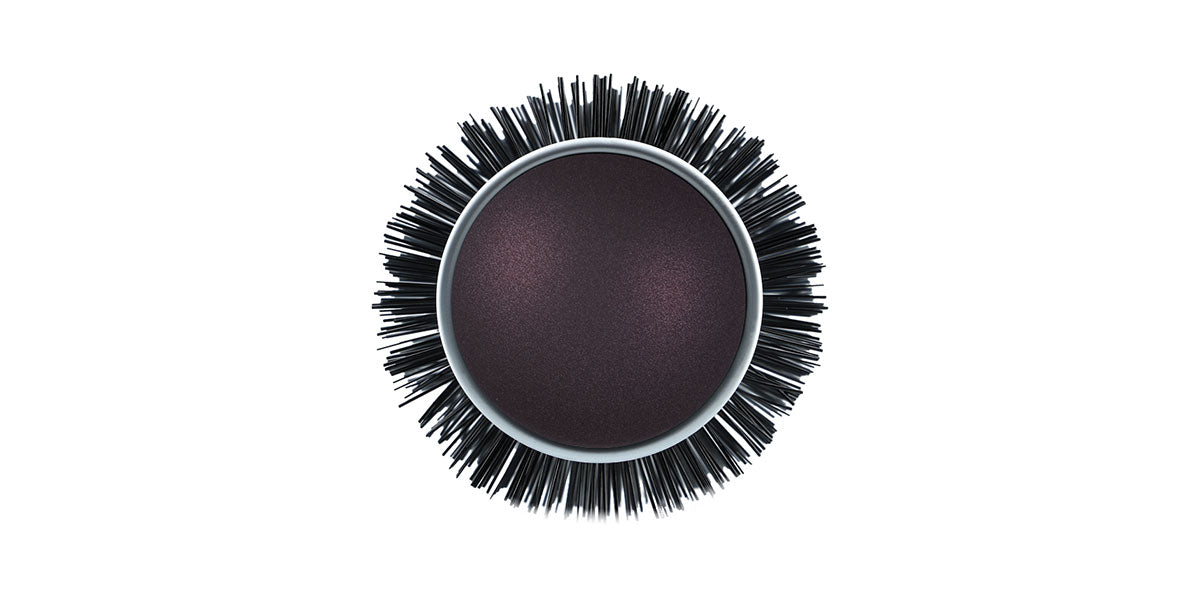 Round brush with black handle.