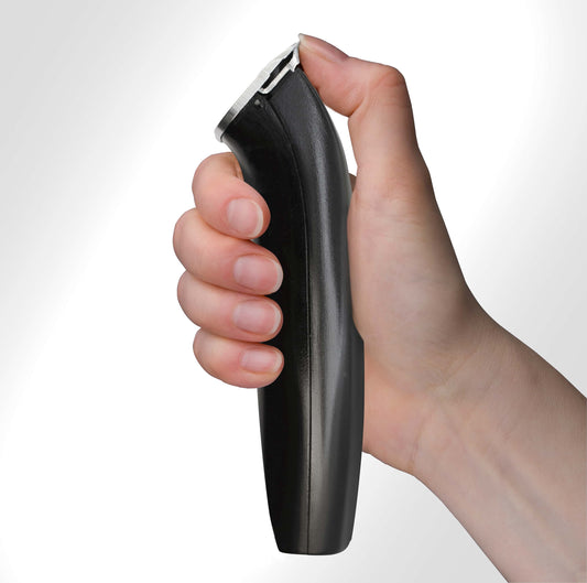 Hand holding black hair clipper.