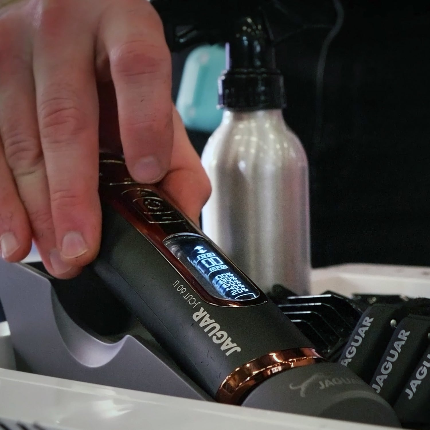 Professional JAGUAR J-CUT Li clipper in the docking station, detail of the LED display.