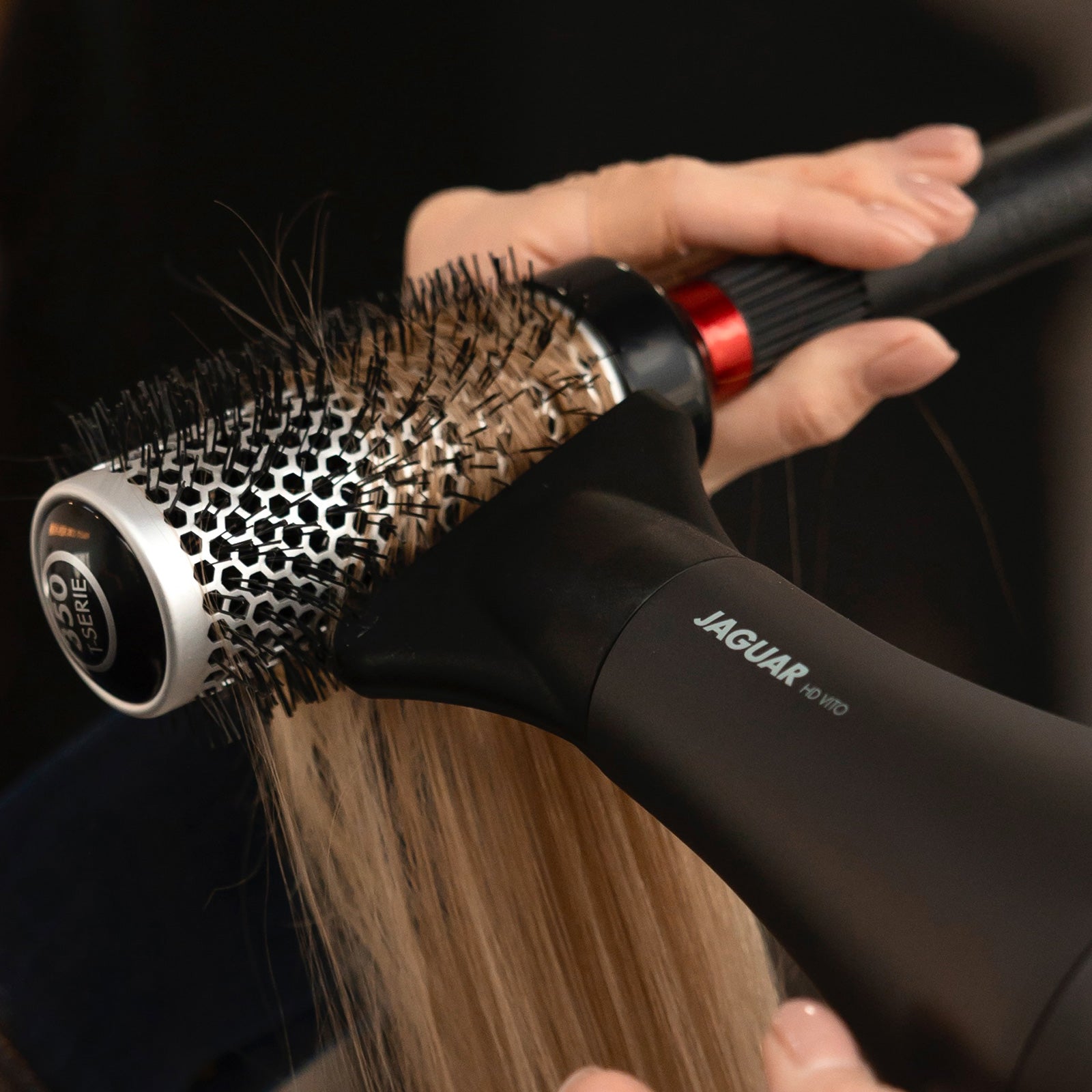 Styling with JAGUAR HD VITO and round brush, close-up of blonde hair being blow-dried.