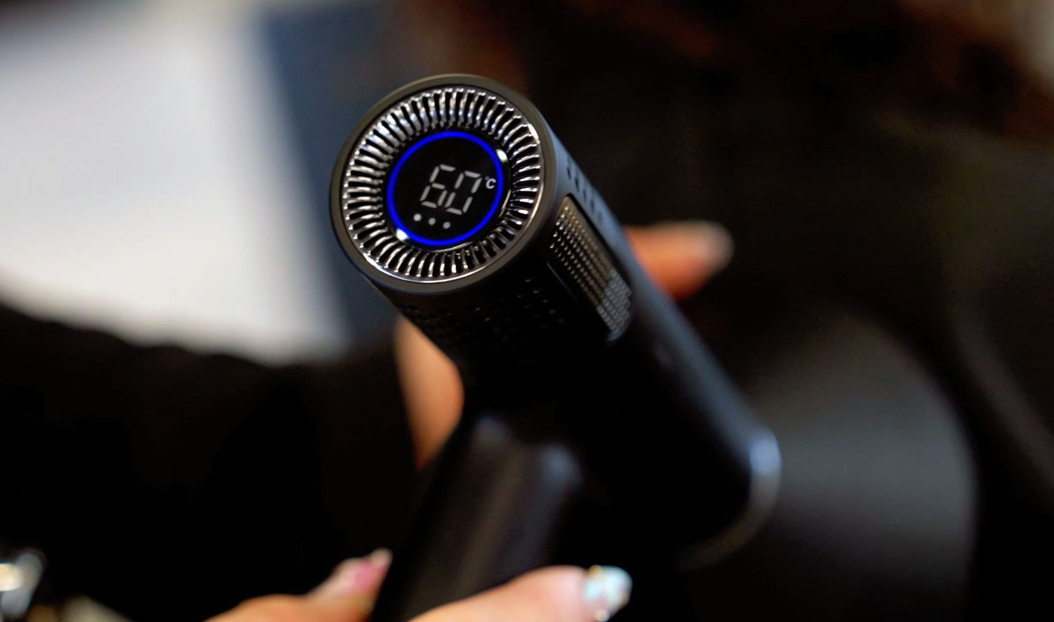 Close-up of JAGUAR Tributo hair dryer with digital temperature display, showing 60 °C.