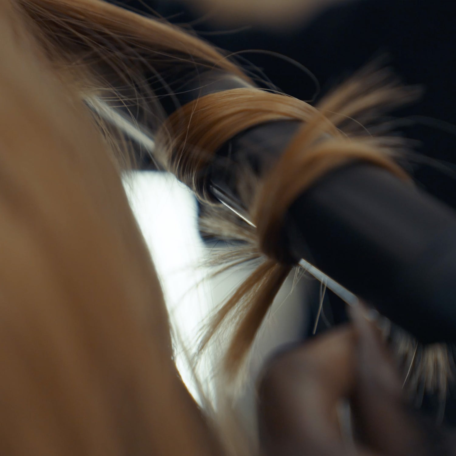 JAGUAR Classic Curl styling tool shaping a curl, close-up.