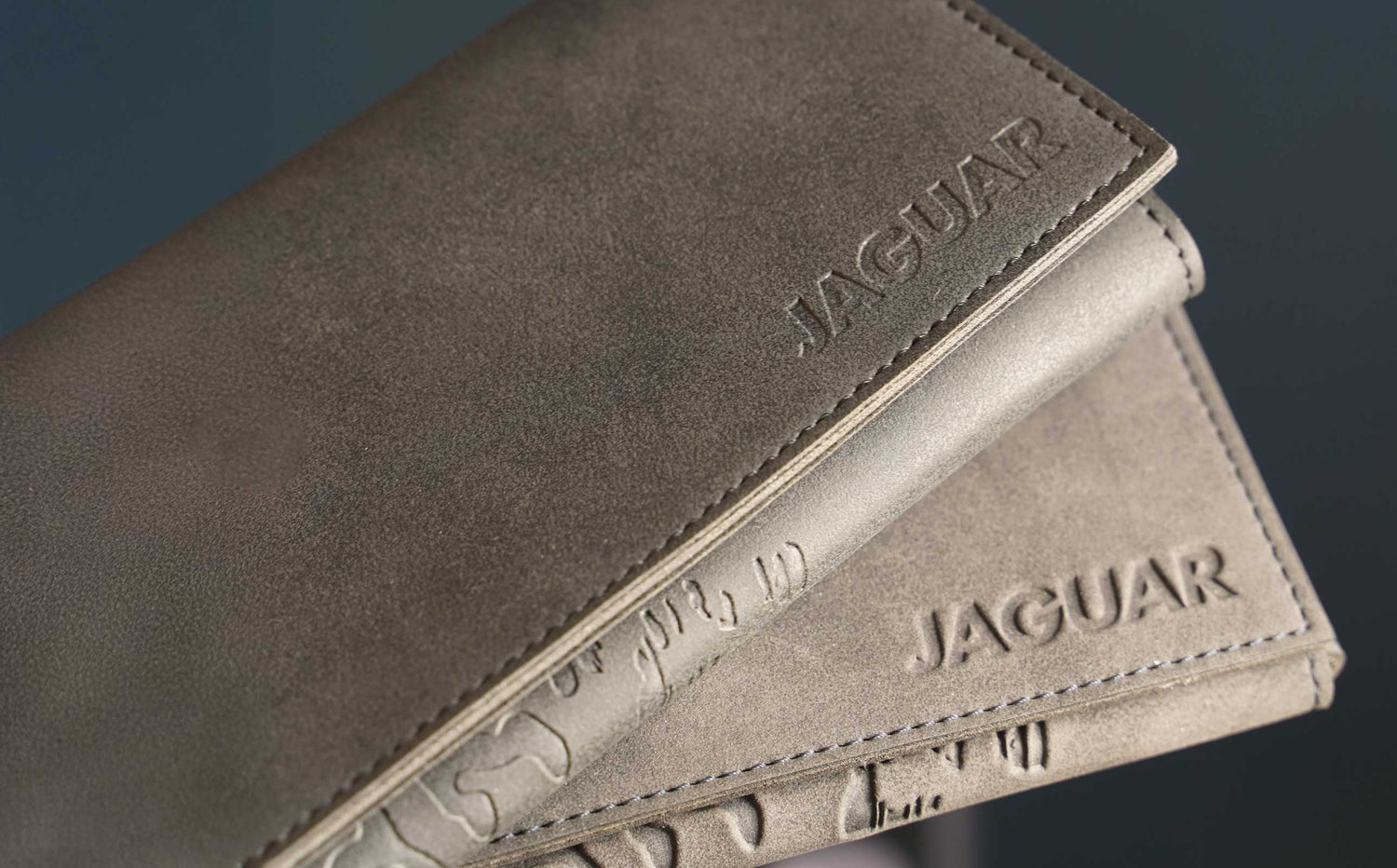 AGUAR leather cases made from robust, high-quality leather – detailed workmanship with embossed logo, durable materials for the safe protection of hairdressing scissors and tools in everyday professional salon use.