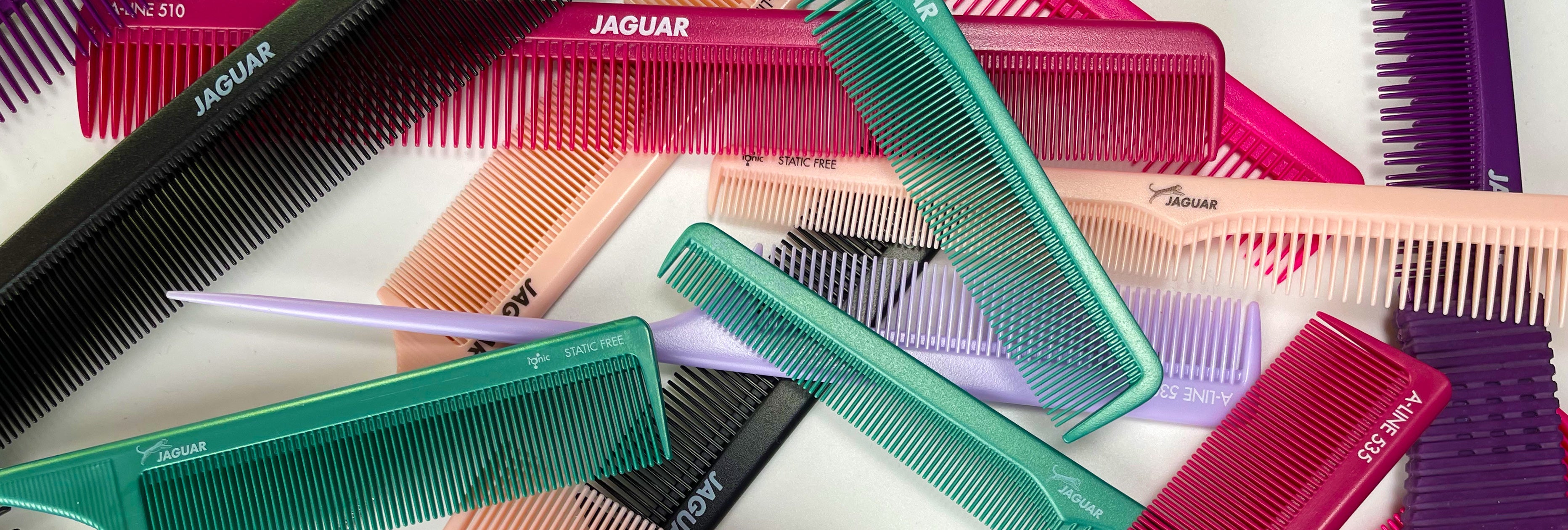 JAGUAR A-Line professional combs in various colors and shapes, scattered on a white background.