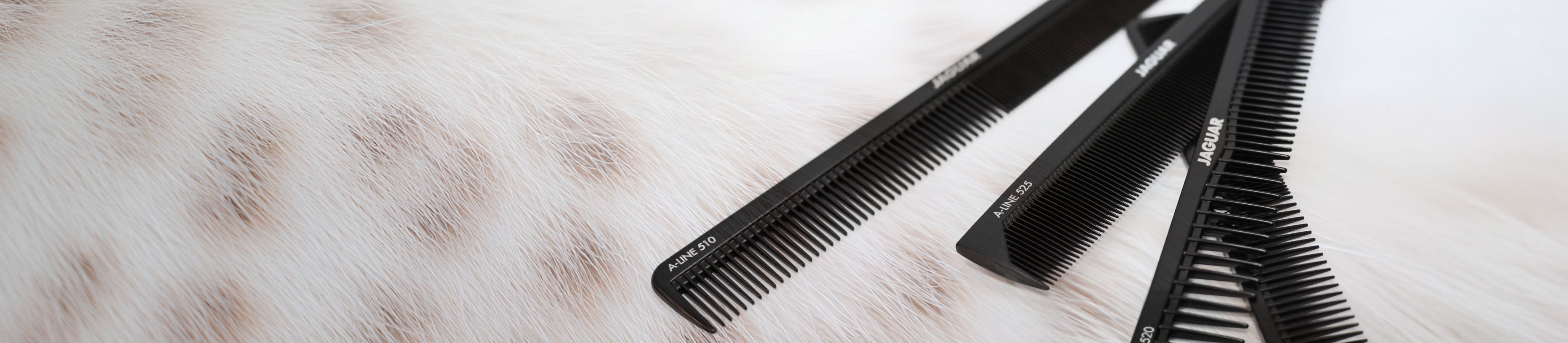 JAGUAR A-Line Black professional combs in various models on a light fur background.