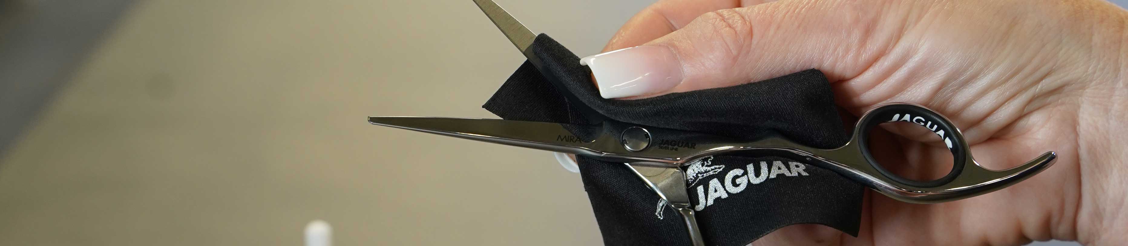 Care of JAGUAR hairdressing scissors with care cloth – cleaning and maintaining the value of professional cutting tools.