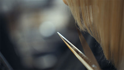 Hairdressing scissors with black handles.