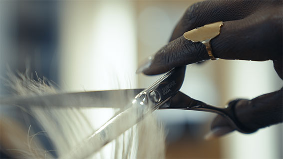 Hairdressing scissors with black handles.