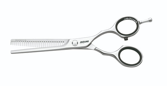 Hairdressing scissors with serrated blades.