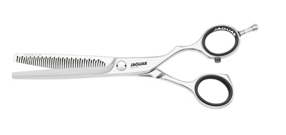 Hairdressing scissors with serrated blades.