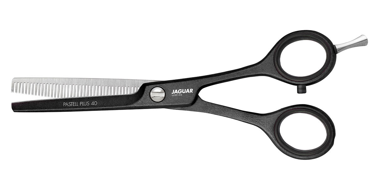 Hairdressing scissors with serrated blades.