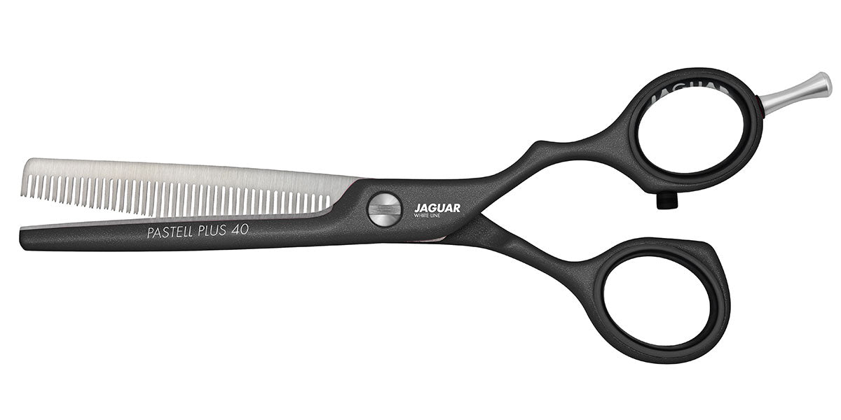 Hairdressing scissors with serrated blades.