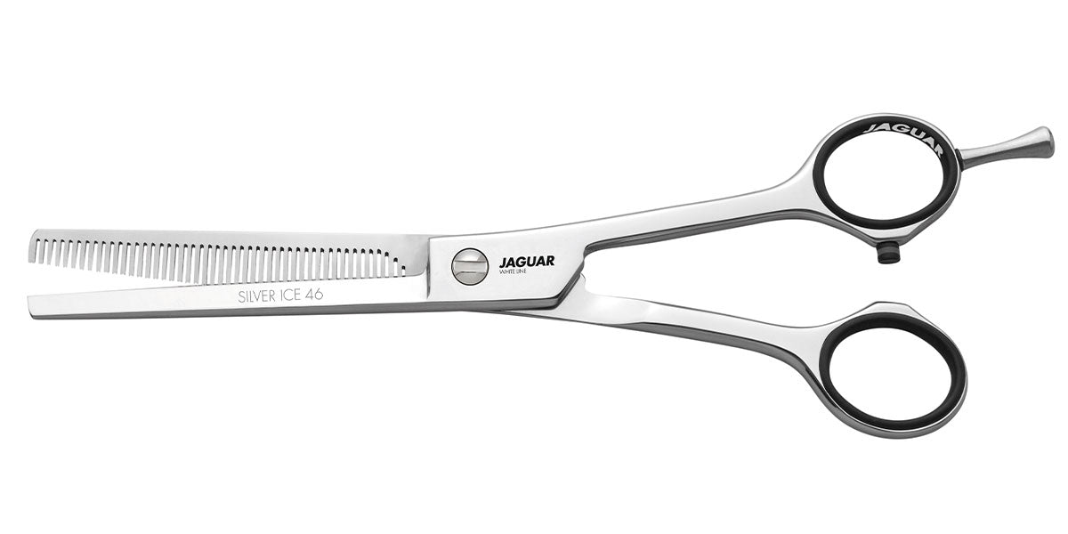 Hairdressing scissors with serrated blades.