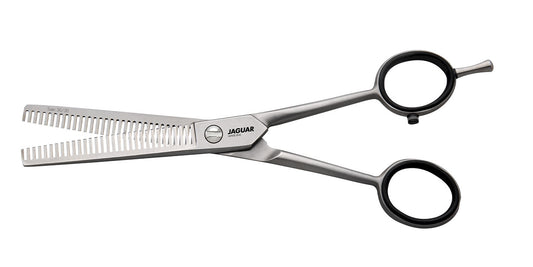 Modeling scissors with black handles.
