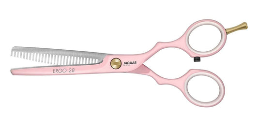 Pink modeling scissors with serrated edges.
