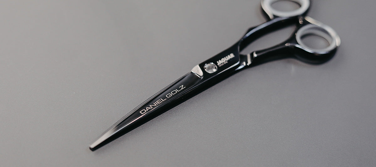 Hairdressing scissors with black handles.