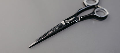 Hairdressing scissors with black handles.