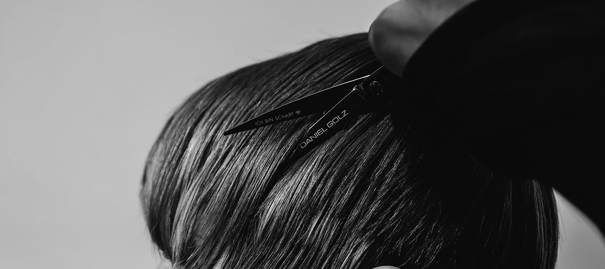 Hairdressing scissors with black handles.