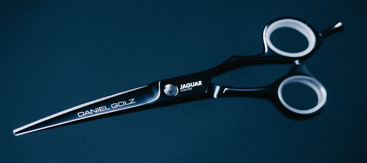 Hairdressing scissors with black handles.