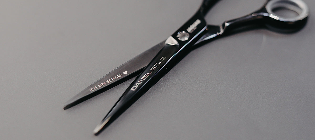 Hairdressing scissors with black handles.