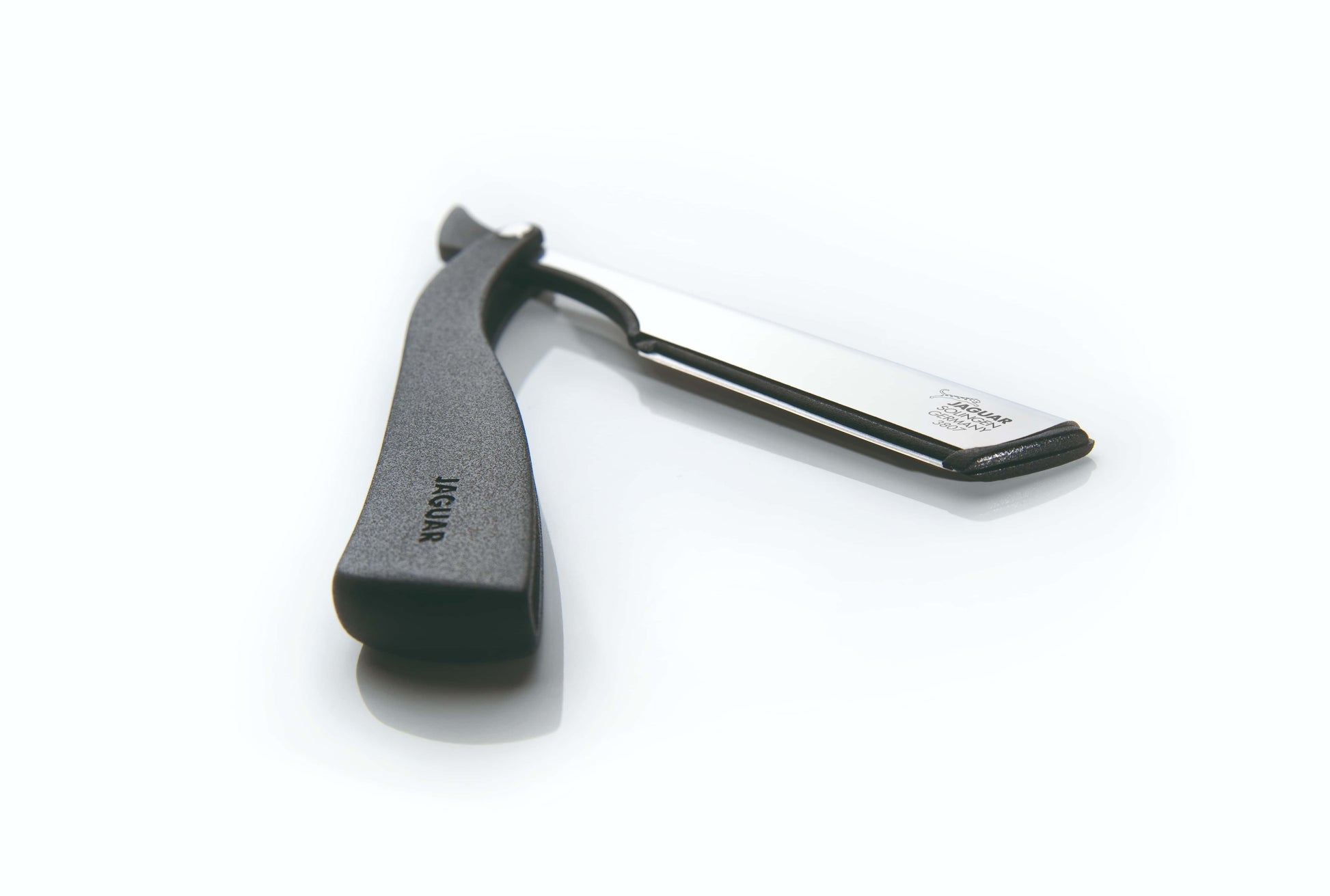 Open razor with black handle.