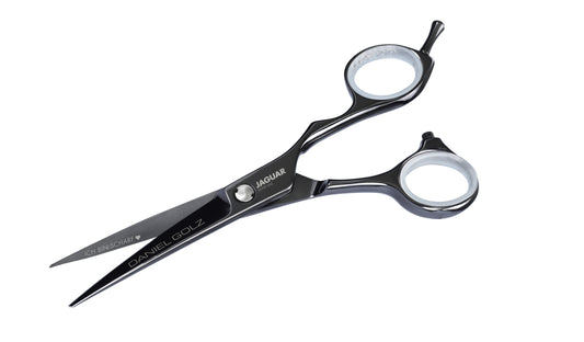Hairdressing scissors with black handles.